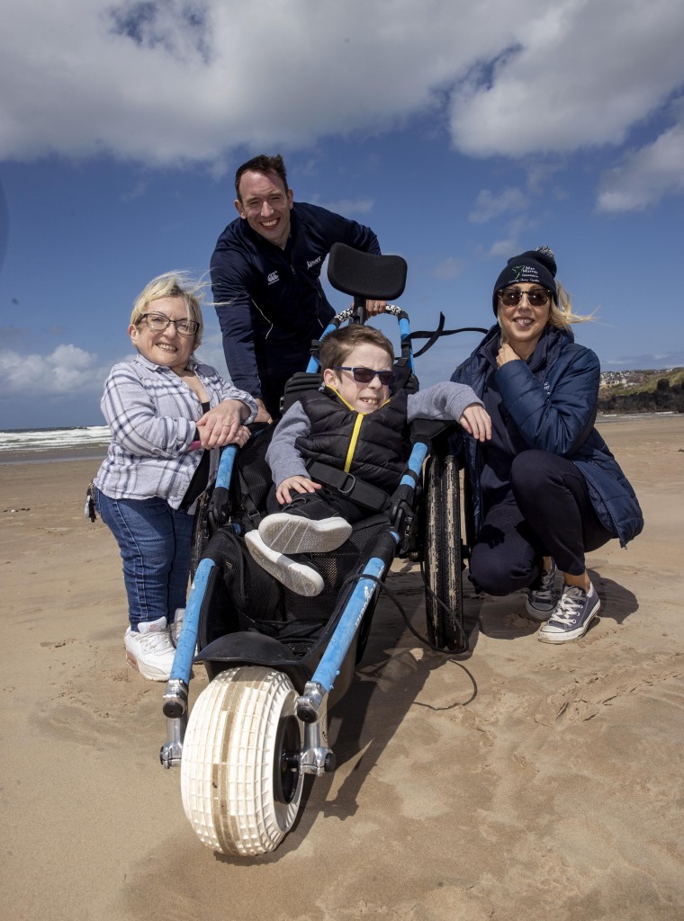 Saul Wilton 12, with his mum Jane Stewart from Portrush, Craig Connor from Sport NI and Alix Crawford Chairperson of the Mae Murray Foundation enjoying Portstewart Strand during the Inclusive Beach launch.