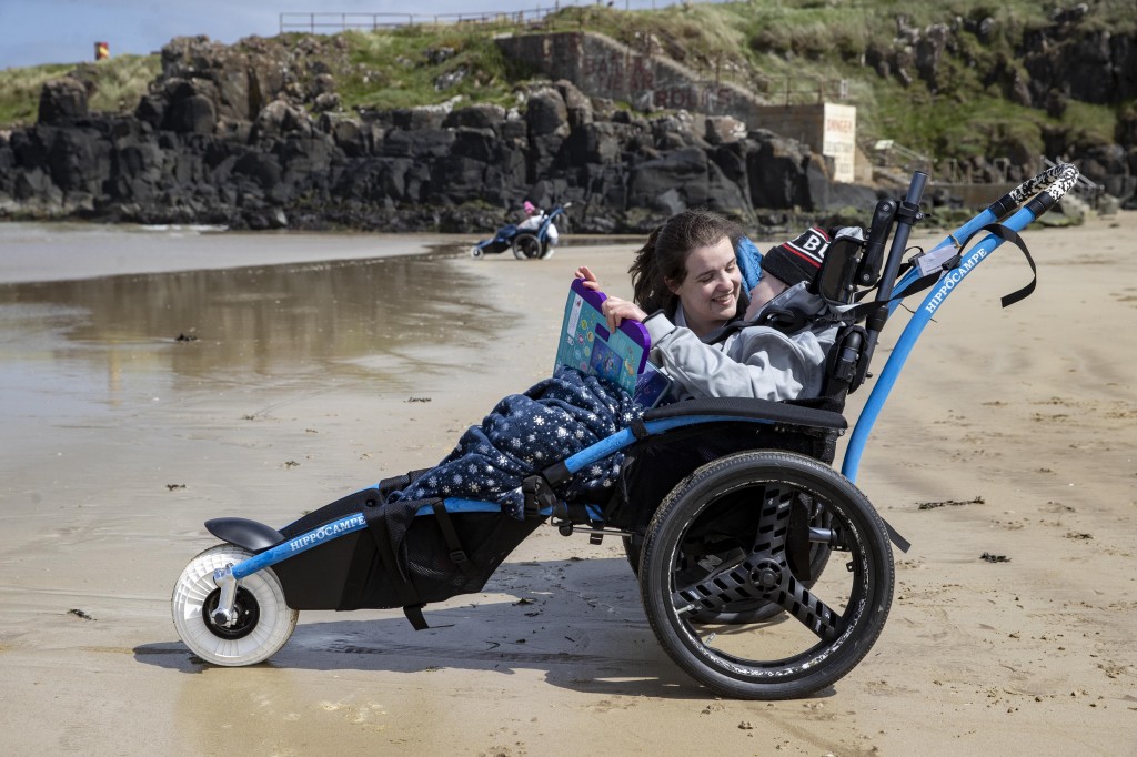 Brothers Callistus and Caleb Hughes with their carers Rebekah and Bethany were the first to use the beach mobility chairs on offer